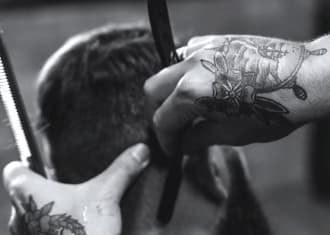 Barber shaves the hair on the client's neck