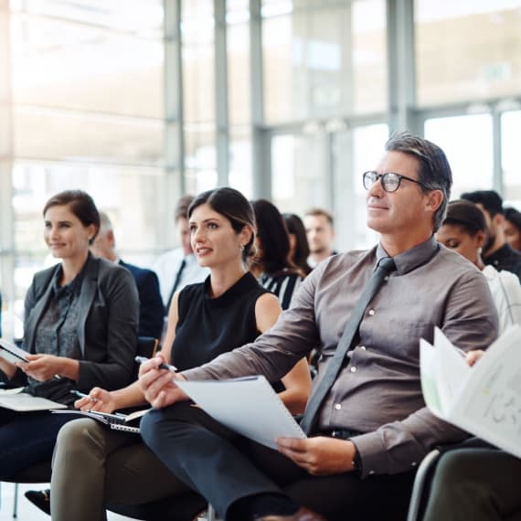 conference guests listen speaker