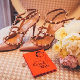 Orange book, women shoes and flowers on the chair
