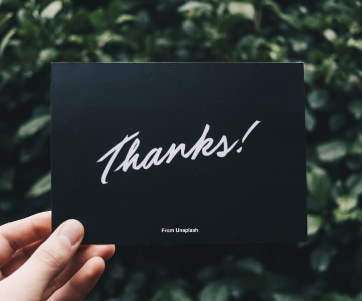 black card with the word Thanks